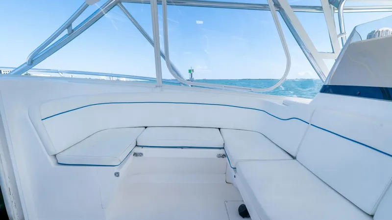 Slide: The Image of 2011 Intrepid 400 Cuddy boat interior with white seating and ocean view. - 19