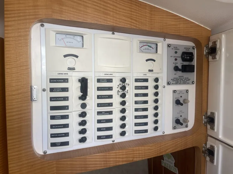 Slide: The Image of Control panel of a 2011 Intrepid 400 Cuddy boat with various switches and gauges. - 31