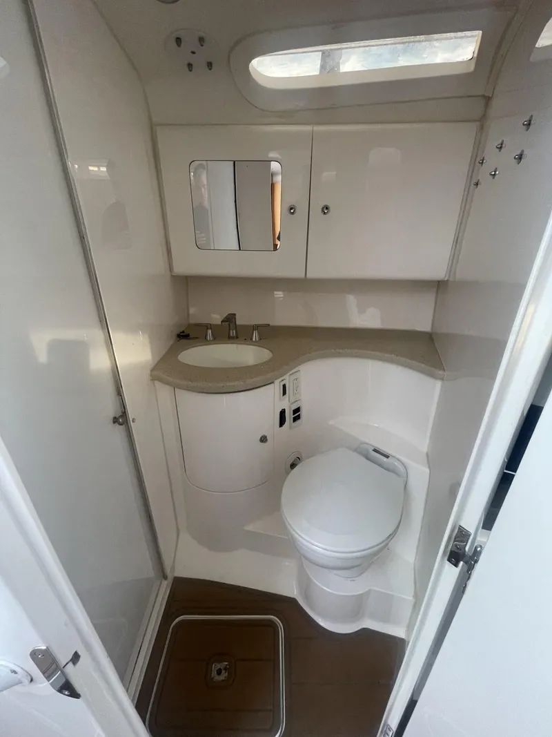 Slide: The Image of 2011 Intrepid 400 Cuddy boat bathroom with sink, toilet, and storage cabinets. - 32