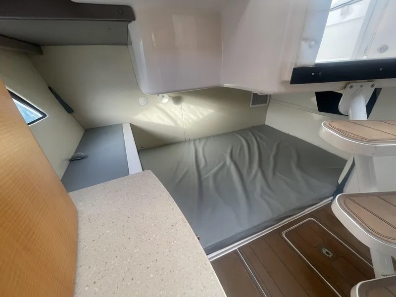 Slide: The Image of Interior cabin of a 2011 Intrepid 400 Cuddy boat with bed and seating area. - 33