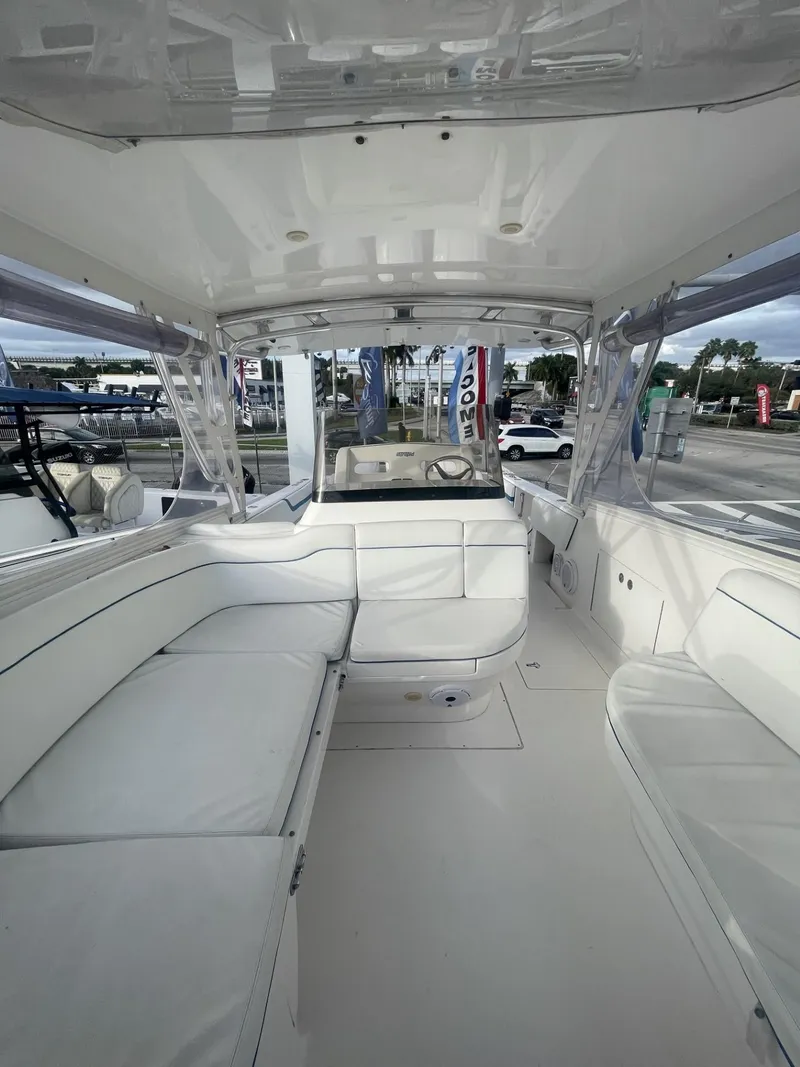 Slide: The Image of 2011 Intrepid 400 Cuddy boat interior with white seating and helm station. - 35