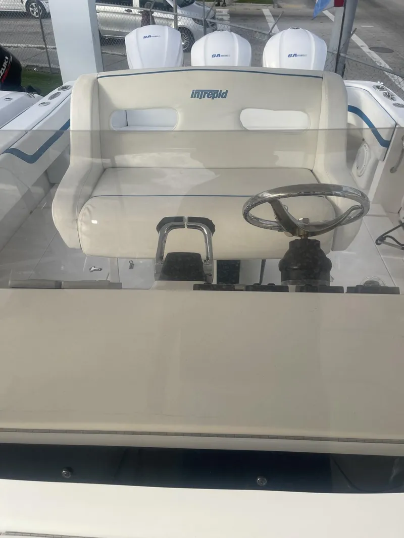 Slide: The Image of 2011 Intrepid 400 Cuddy boat helm with steering wheel and seating. - 38