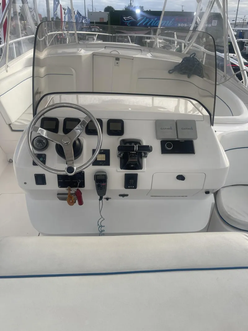 Slide: The Image of 2011 Intrepid 400 Cuddy boat helm with steering wheel and controls. - 39