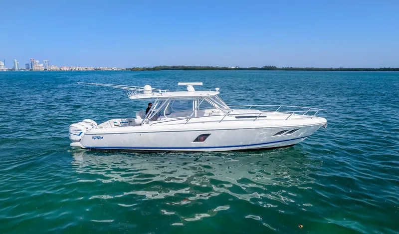 Slide: The Image of 2011 Intrepid 400 Cuddy boat on clear blue water. - 4