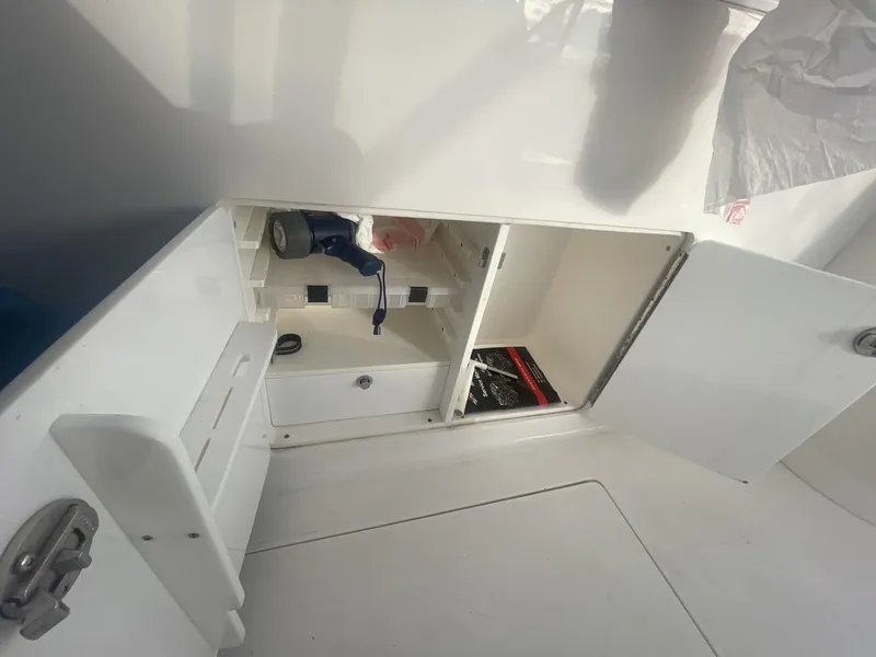 Slide: The Image of Storage compartment of a 2011 Intrepid 400 Cuddy boat with open doors. - 41
