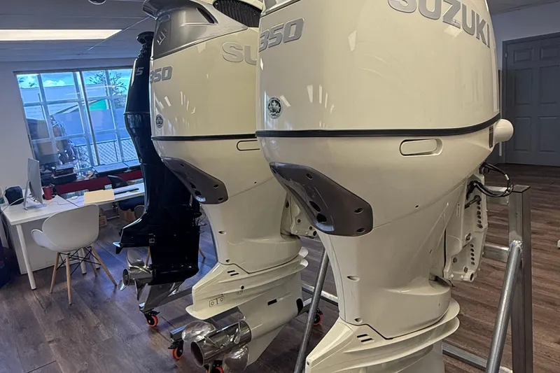 Slide: The Image of Suzuki 350 outboard motors displayed indoors, near a desk and chair. - 45