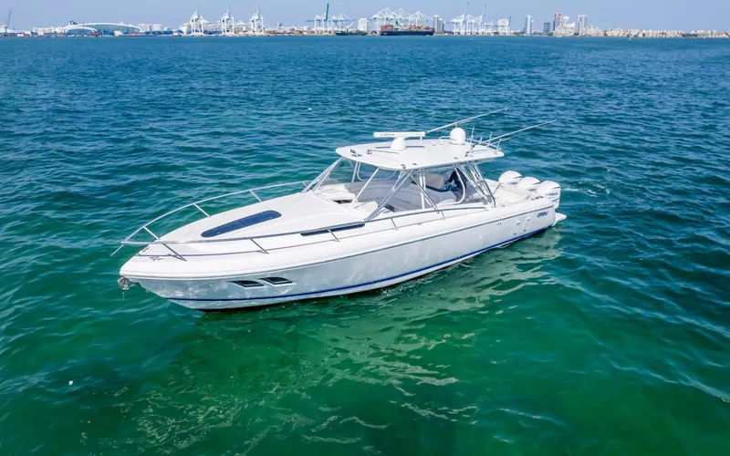 Slide: The Image of 2011 Intrepid 400 Cuddy boat on clear blue water with cityscape background. - 5