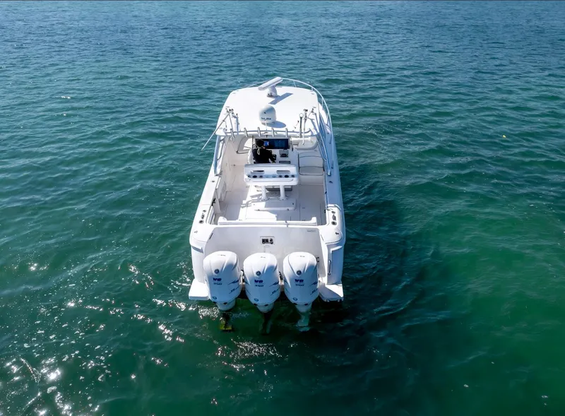Slide: The Image of 2011 Intrepid 400 Cuddy boat with triple outboard engines on open water. - 7