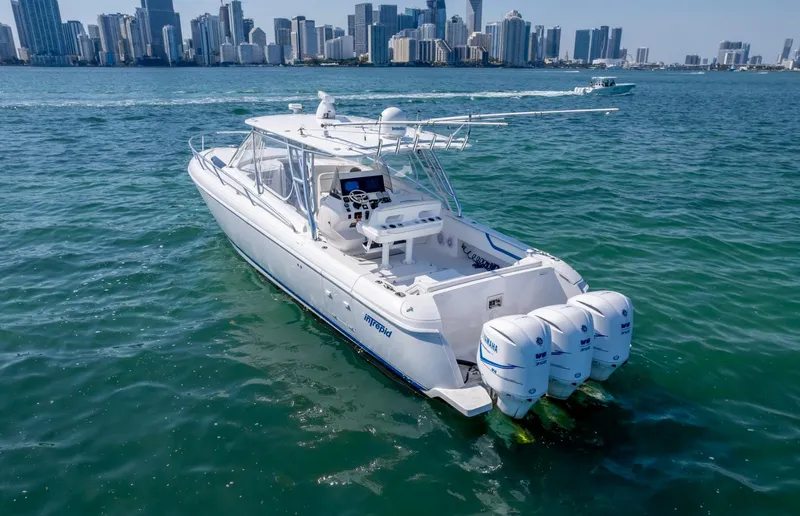 Slide: The Image of 2011 Intrepid 400 Cuddy cruising in coastal waters with city skyline in background. - 9