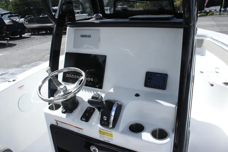Slide: The Image of 2025 Sea Pro 242 Deep-V boat console with steering wheel and navigation equipment. - 11