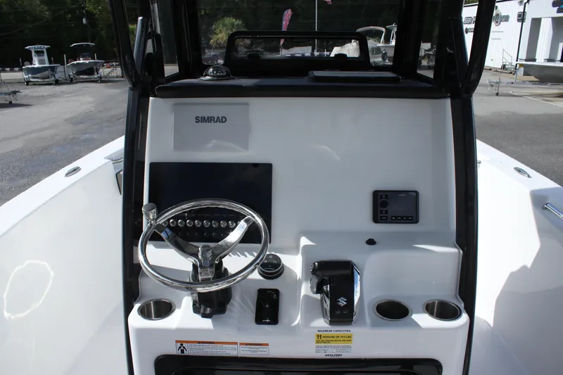 Slide: The Image of 2025 Sea Pro 242 Deep-V boat console with steering wheel and navigation controls. - 12