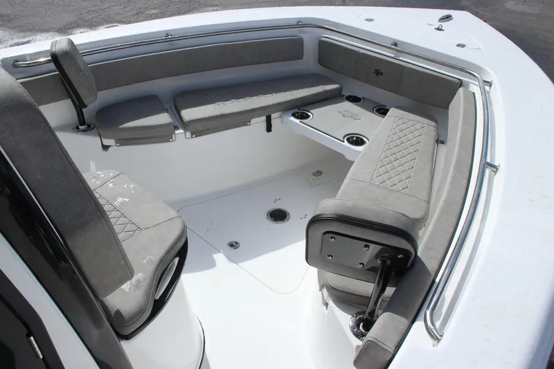 Slide: The Image of 2025 Sea Pro 242 Deep-V boat interior with cushioned seating and cup holders. - 21