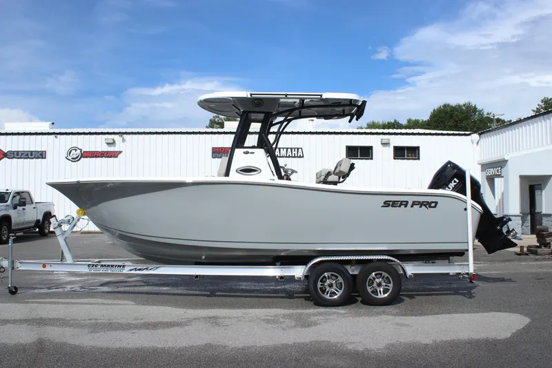 Slide: The Image of 2025 Sea Pro 242 Deep-V boat on a trailer outside a dealership. - 3
