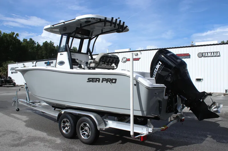 Slide: The Image of 2025 Sea Pro 242 Deep-V boat on a trailer with Suzuki outboard motor. - 4