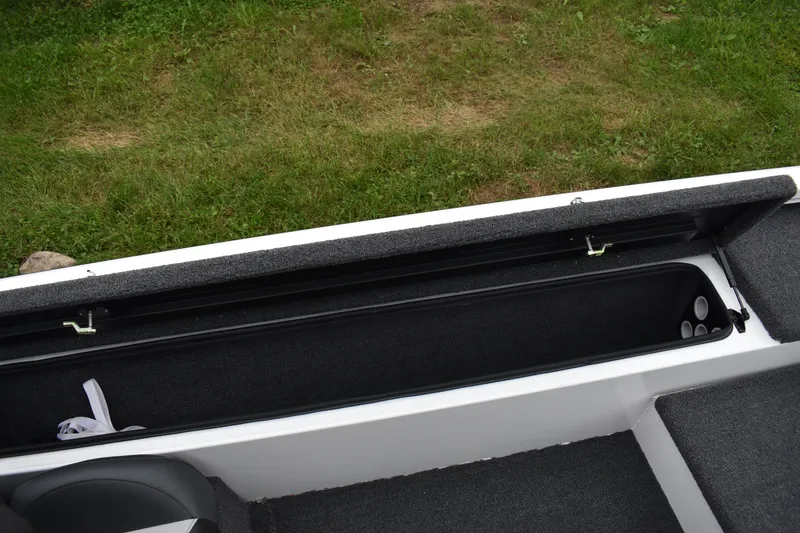 Slide: The Image of 2023 Vexus AVX189C boat storage compartment with open lid, showcasing interior space. - 11