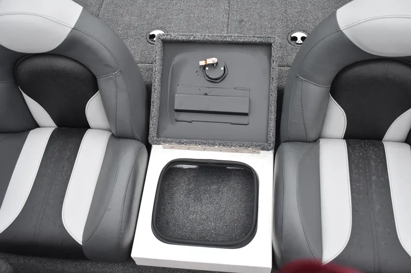 Slide: The Image of 2023 Vexus AVX189C boat interior with storage compartment between seats. - 13