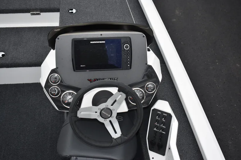 Slide: The Image of 2023 Vexus AVX189C boat dashboard with steering wheel and electronic display. - 2