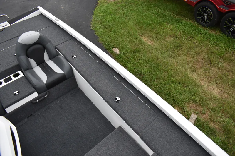 Slide: The Image of 2023 Vexus AVX189C boat interior with gray seating and storage compartments. - 5