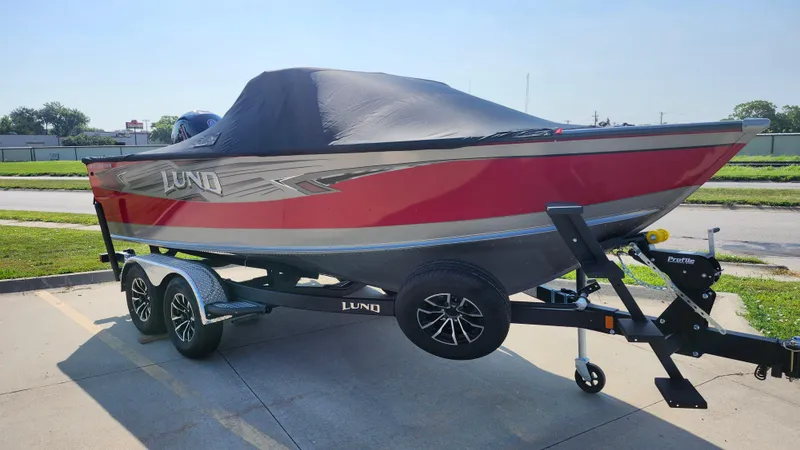 Slide: The Image of 2025 Lund 1875 Fisherman boat on trailer, covered, parked outdoors. - 11