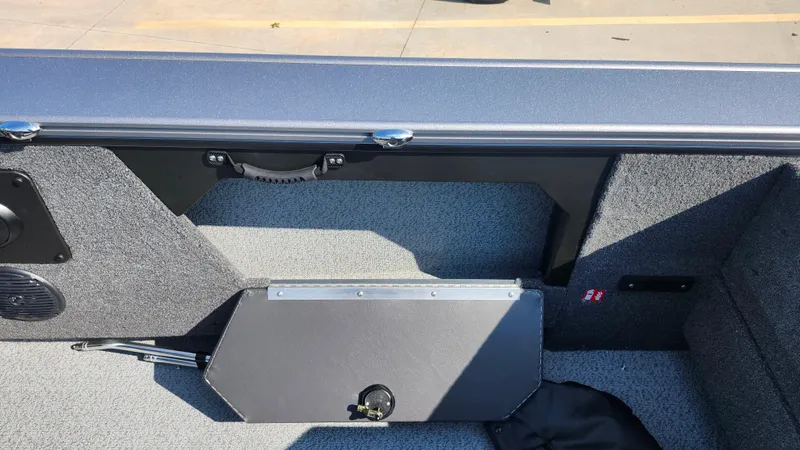 Slide: The Image of 2025 Lund 1875 Fisherman boat interior with storage compartment and speaker. - 15