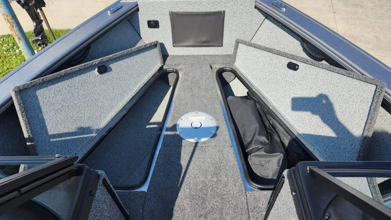 Slide: The Image of 2025 Lund 1875 Fisherman boat interior with open storage compartments. - 18