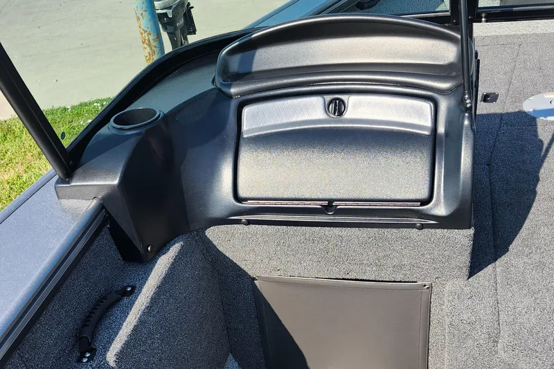 Slide: The Image of 2025 Lund 1875 Fisherman boat interior with storage compartment and cup holder. - 21