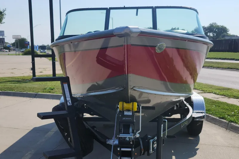 Slide: The Image of 2025 Lund 1875 Fisherman boat on trailer, parked outdoors. - 5
