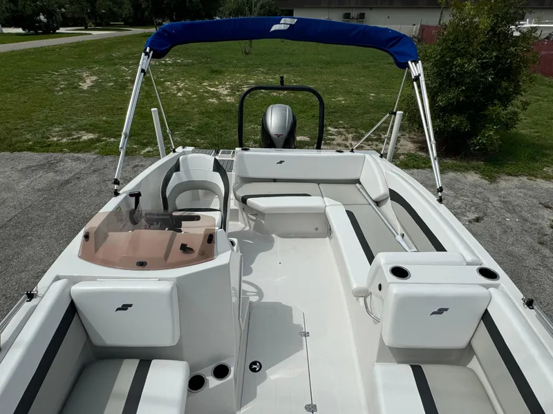 Slide: The Image of 2023 Starcraft SVX 171 OB boat with seating and blue canopy on a sunny day. - 12