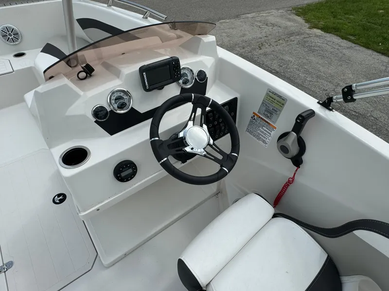 Slide: The Image of 2023 Starcraft SVX 171 OB boat cockpit with steering wheel and controls. - 13