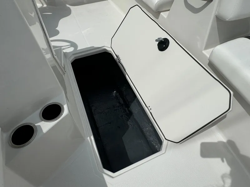 Slide: The Image of 2023 Starcraft SVX 171 OB boat storage compartment open, showing interior space. - 19
