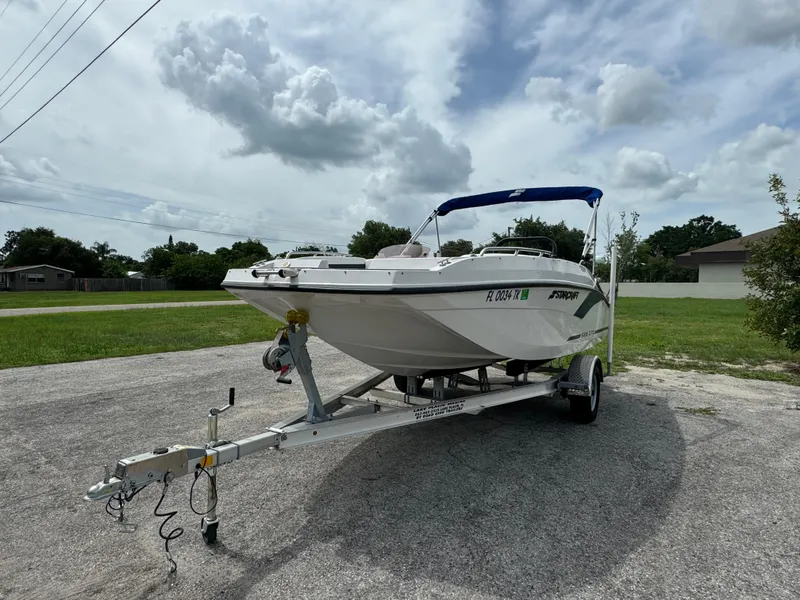 Slide: The Image of 2023 Starcraft SVX 171 OB boat on trailer under cloudy sky. - 2
