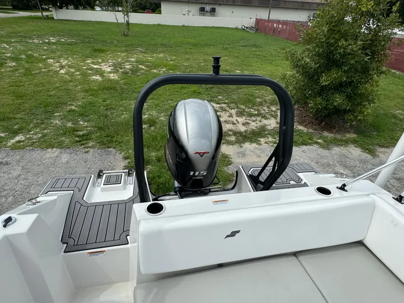 Slide: The Image of 2023 Starcraft SVX 171 OB boat with 115 HP outboard motor, parked on grass. - 24