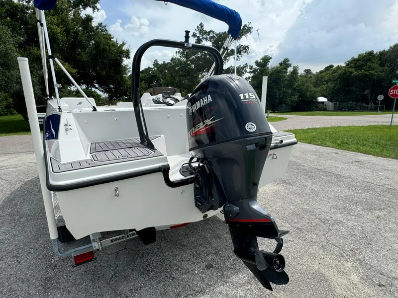 Slide: The Image of 2023 Starcraft SVX 171 OB boat with Yamaha 115 outboard motor, parked on a driveway. - 27