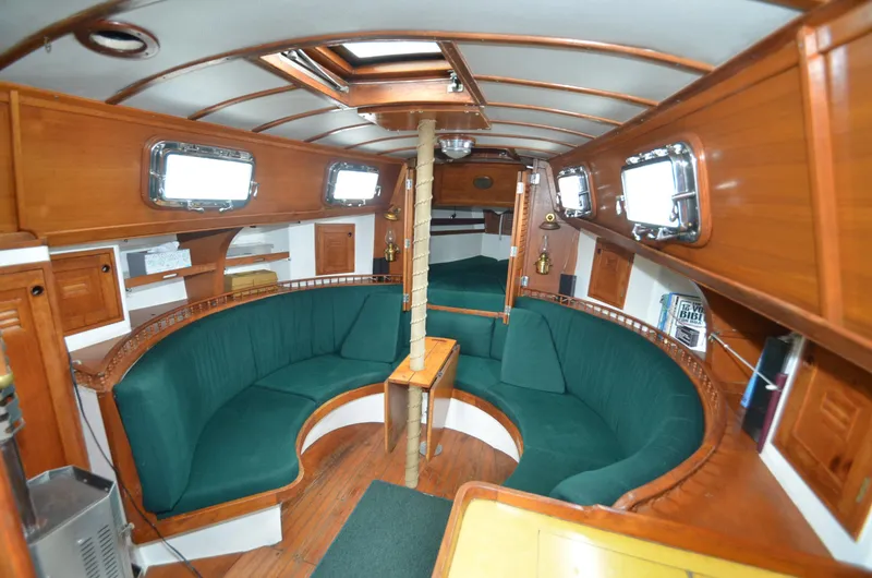 Slide: The Image of Interior of 1978 Cheoy Lee Offshore 32 sailboat with green seating and wooden finishes. - 17