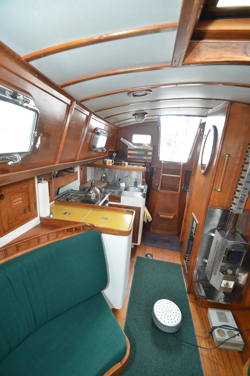 Slide: The Image of Interior of 1978 Cheoy Lee Offshore 32 sailboat with wooden finishes and compact kitchen. - 21
