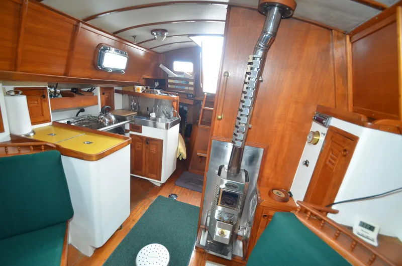 Slide: The Image of Interior of 1978 Cheoy Lee Offshore 32 sailboat with wood paneling and compact kitchen. - 24