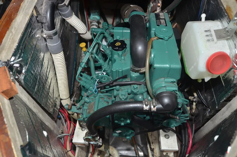 Slide: The Image of Engine compartment of 1978 Cheoy Lee Offshore 32 sailboat, featuring a green marine engine. - 35