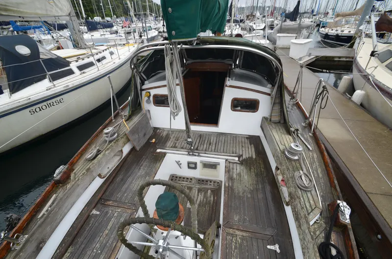 Slide: The Image of 1978 Cheoy Lee Offshore 32 sailboat docked at marina, wooden deck, classic design. - 4