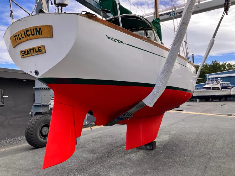 Slide: The Image of 1978 Cheoy Lee Offshore 32 sailboat with vibrant red hull, docked in Seattle. - 43