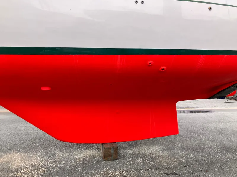 Slide: The Image of 1978 Cheoy Lee Offshore 32 sailboat hull with vibrant red paint. - 44