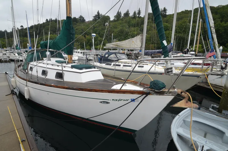 Slide: The Image of 1978 Cheoy Lee Offshore 32 sailboat docked in a marina, surrounded by other boats. - 5