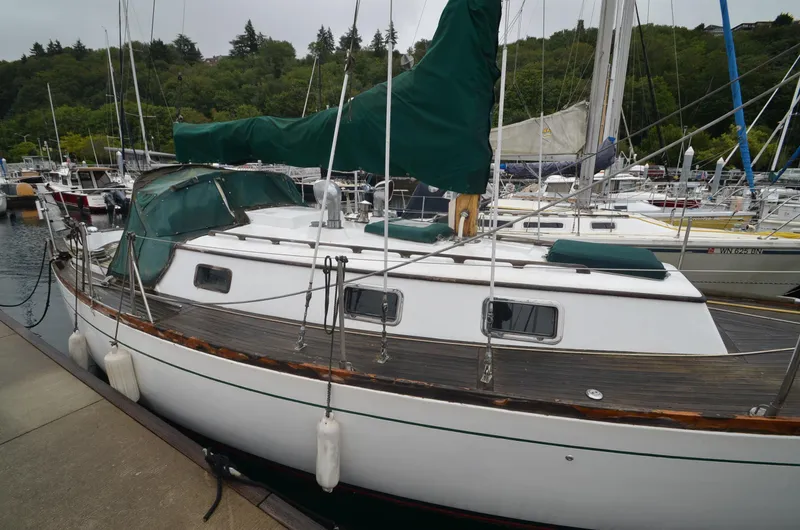 Slide: The Image of 1978 Cheoy Lee Offshore 32 sailboat docked in a marina, surrounded by other boats. - 7
