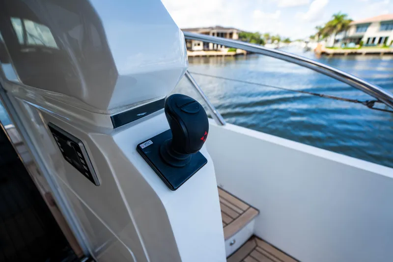 Slide: The Image of Joystick control on 2018 Princess F62 yacht, docked by waterfront homes. - 12