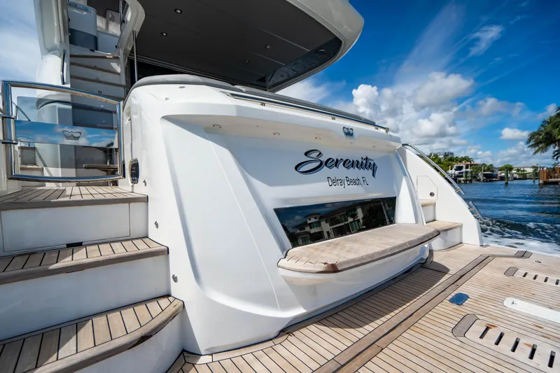 Slide: The Image of 2018 Princess F62 yacht Serenity docked, featuring teak steps and swim platform. - 13