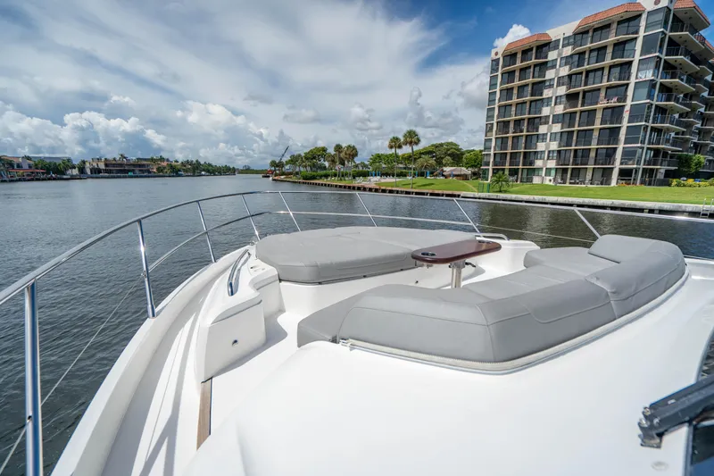 Slide: The Image of 2018 Princess F62 yacht with spacious deck, docked near waterfront condos. - 14