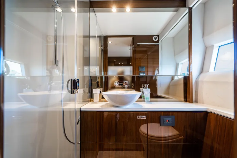 Slide: The Image of Luxurious bathroom in a 2018 Princess F62 yacht with modern fixtures and wooden cabinetry. - 24