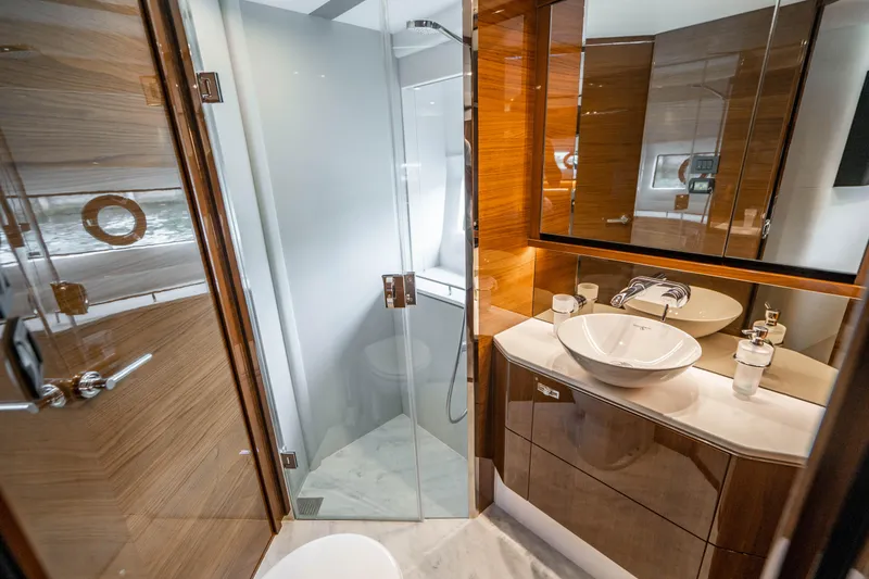 Slide: The Image of Luxurious bathroom in a 2018 Princess F62 yacht with modern fixtures and glass shower. - 25