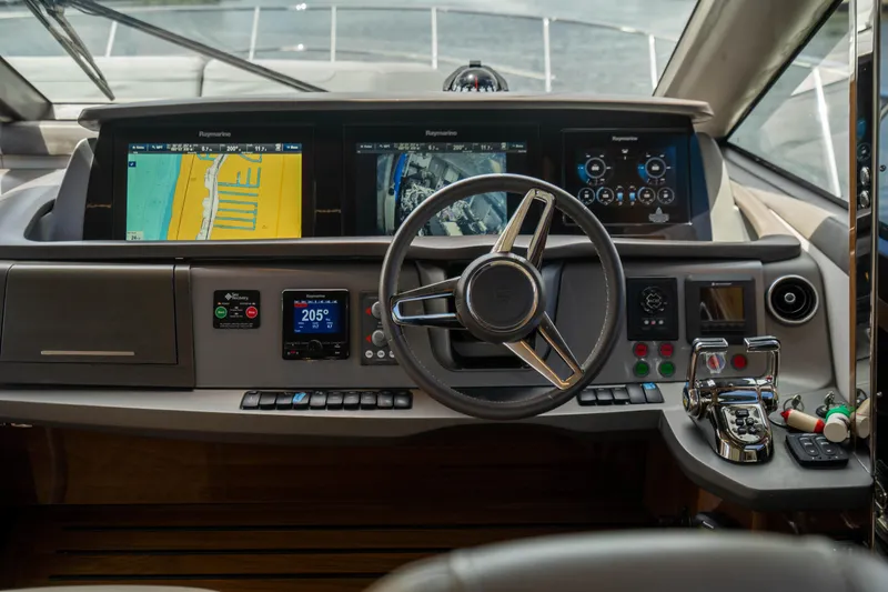 Slide: The Image of 2018 Princess F62 yacht helm with navigation screens and controls. - 9
