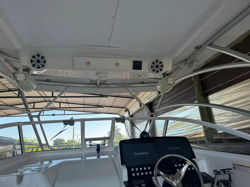 Slide: The Image of 2006 Pro-Line 32 Express boat interior with Garmin navigation system and steering wheel. - 11