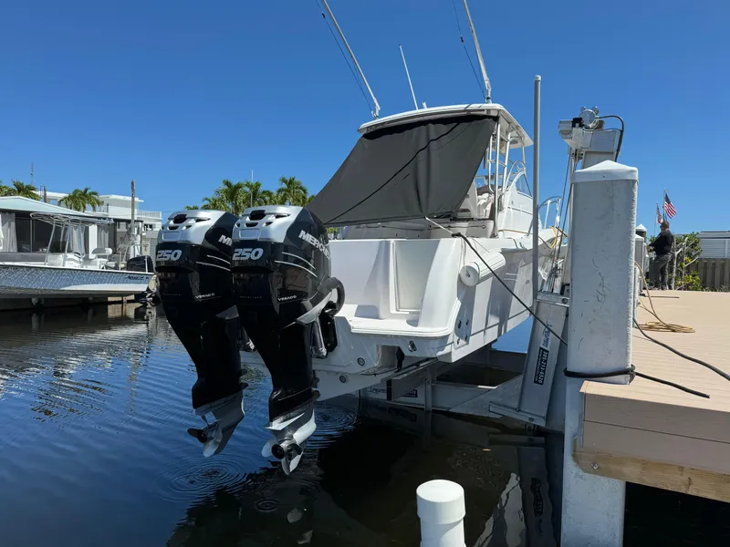 Slide: The Image of 2006 Pro-Line 32 Express boat with twin outboard motors docked in marina. - 2